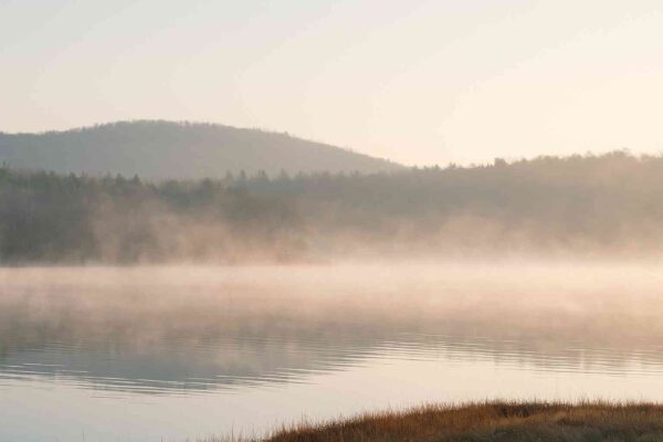 What Are Some Common Misconceptions About Mindfulness Meditation? 14 A peaceful morning landscape with mist over a calm lake, symbolizing mindfulness, inner calm, and deep awareness.